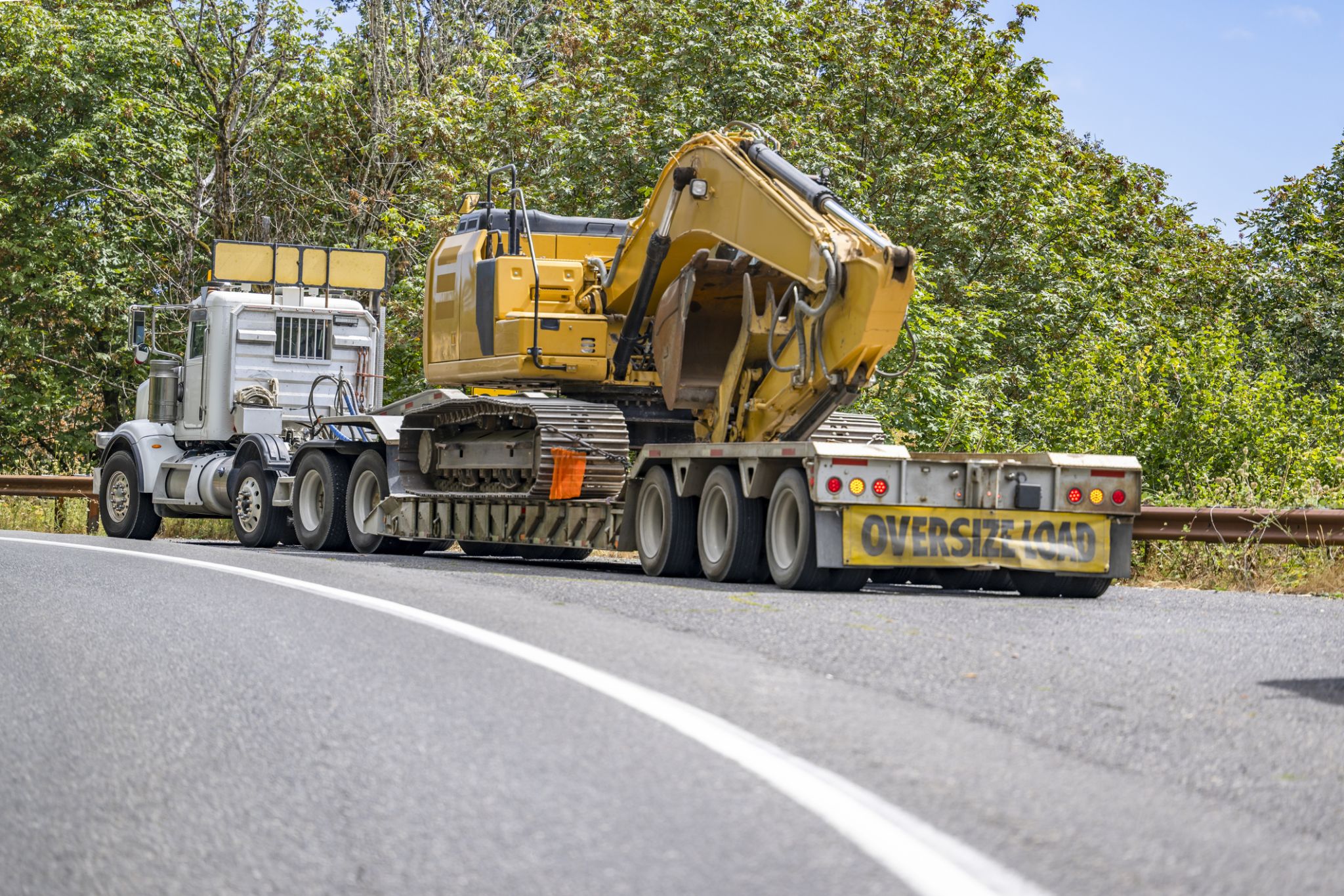 double drop trailer hauling a tractor