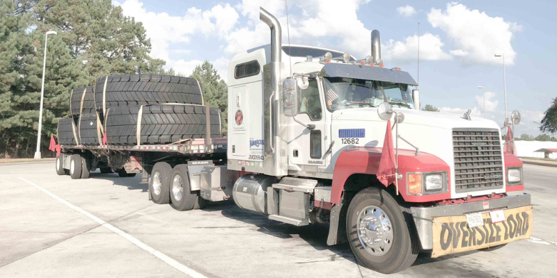 oversized tire load on a flatbed trailer
