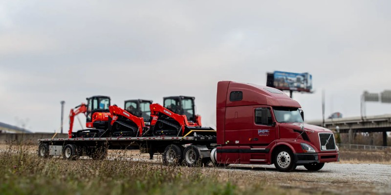 skid steer on Mercer Transportation flatbed truck